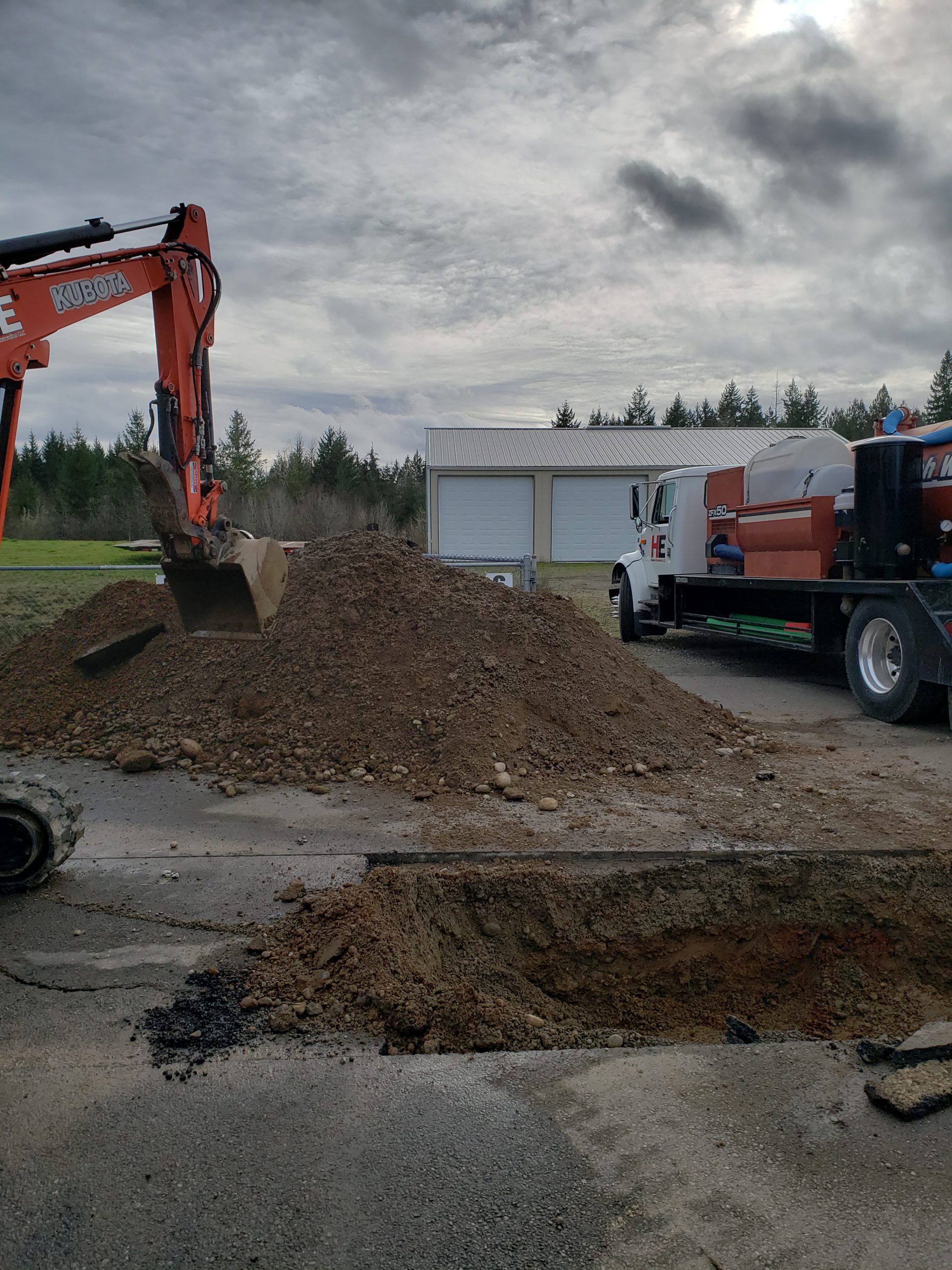 Crews remove dirt from the area around the water main.