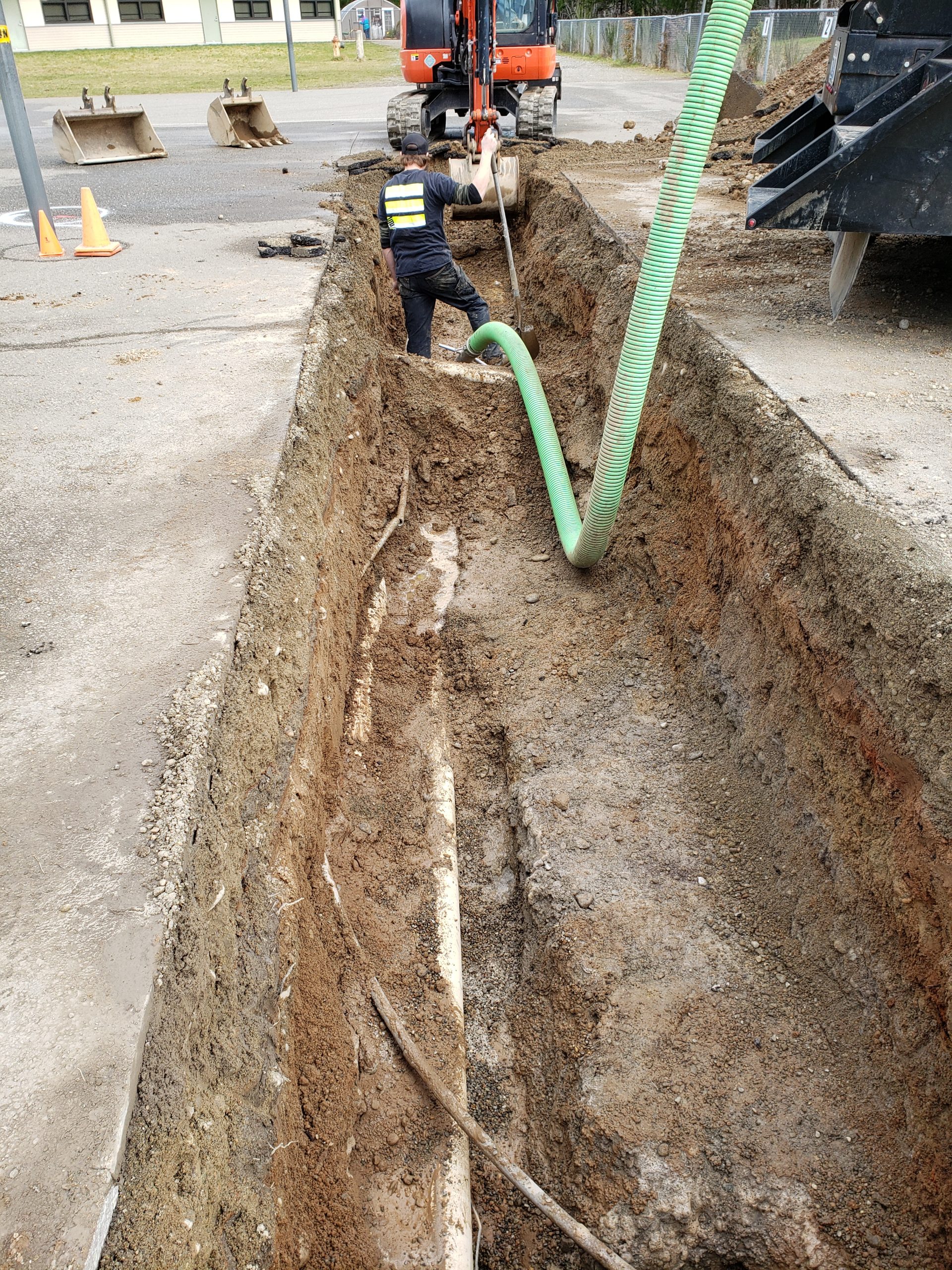 Crews work in the trench around the Pioneer Elementary Water Main