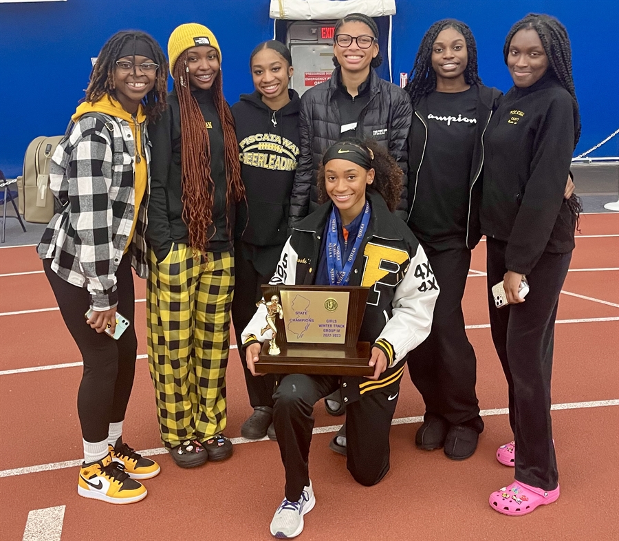 girls track team with trophy