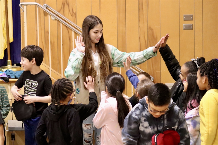 girls scout high-fiving students