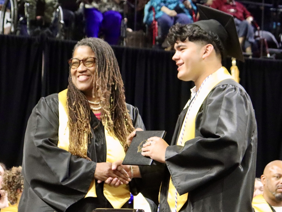 board president giving out diploma