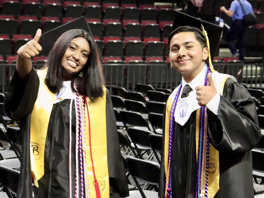 graduates giving thumbs up