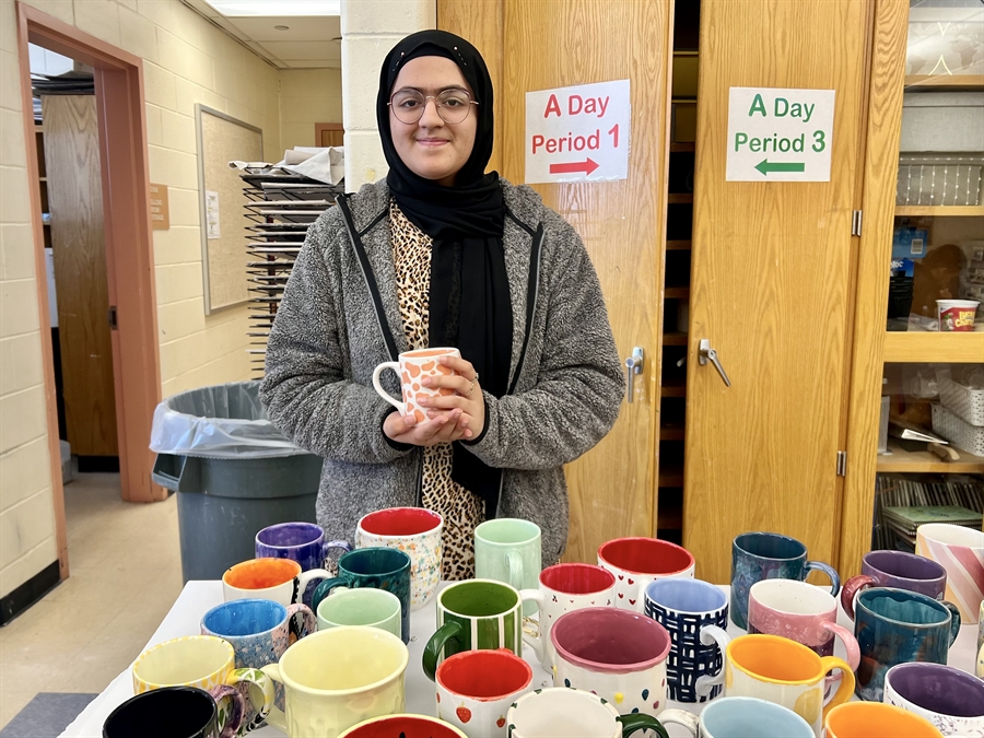 student holding finished mug