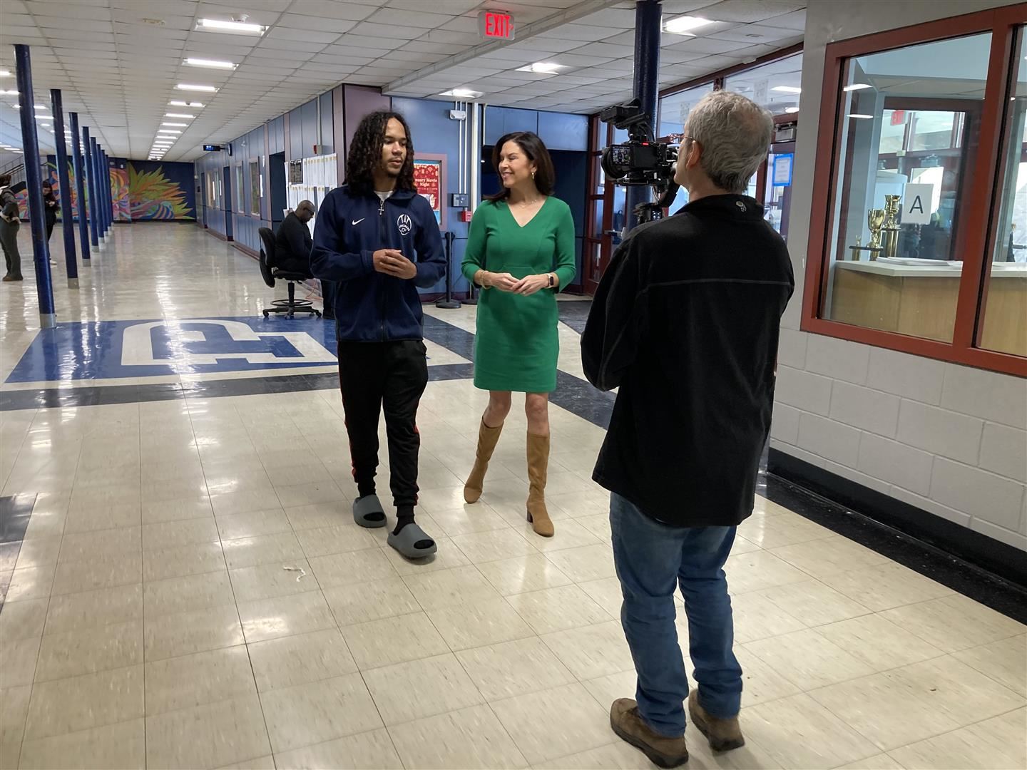  Timothy Evans is interviewed by CBS's Meg Oliver as they are recorded walking down a hallway