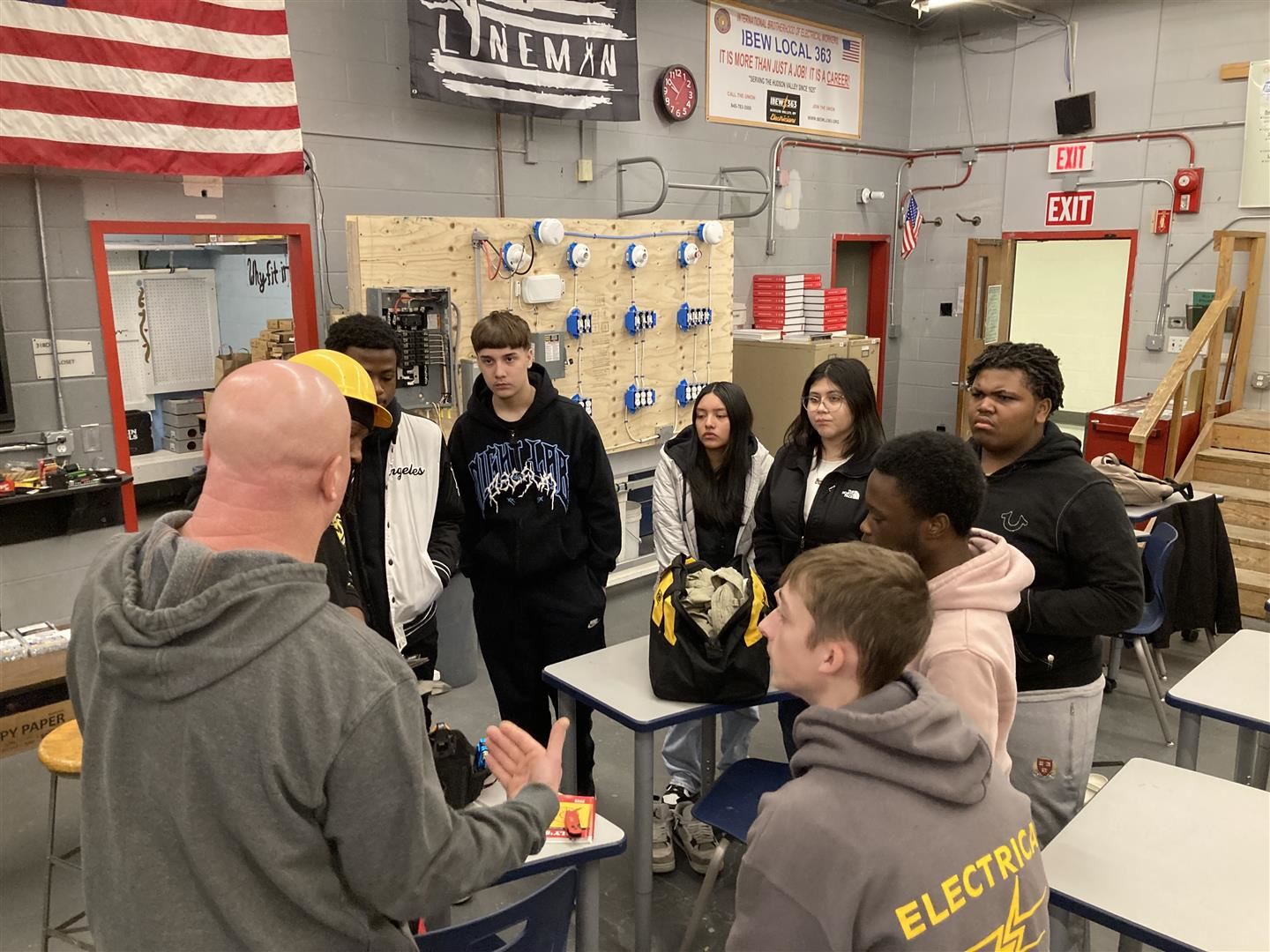  Students in a construction classroom listen to a teacher