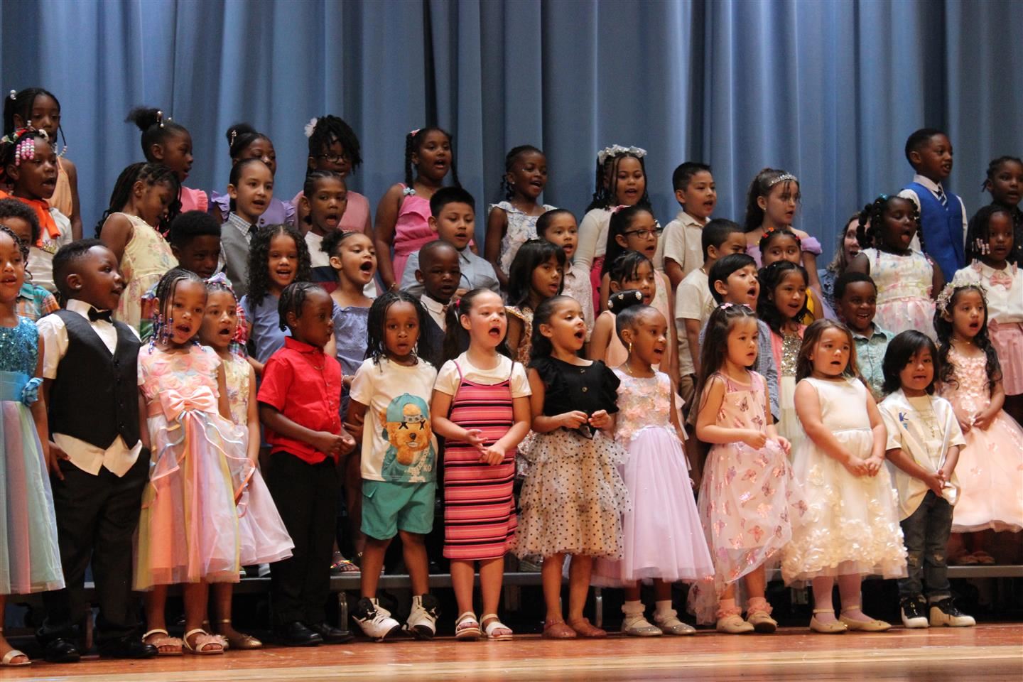  Kindergarten students sang pop songs with special school-themed lyrics at moving up ceremonies