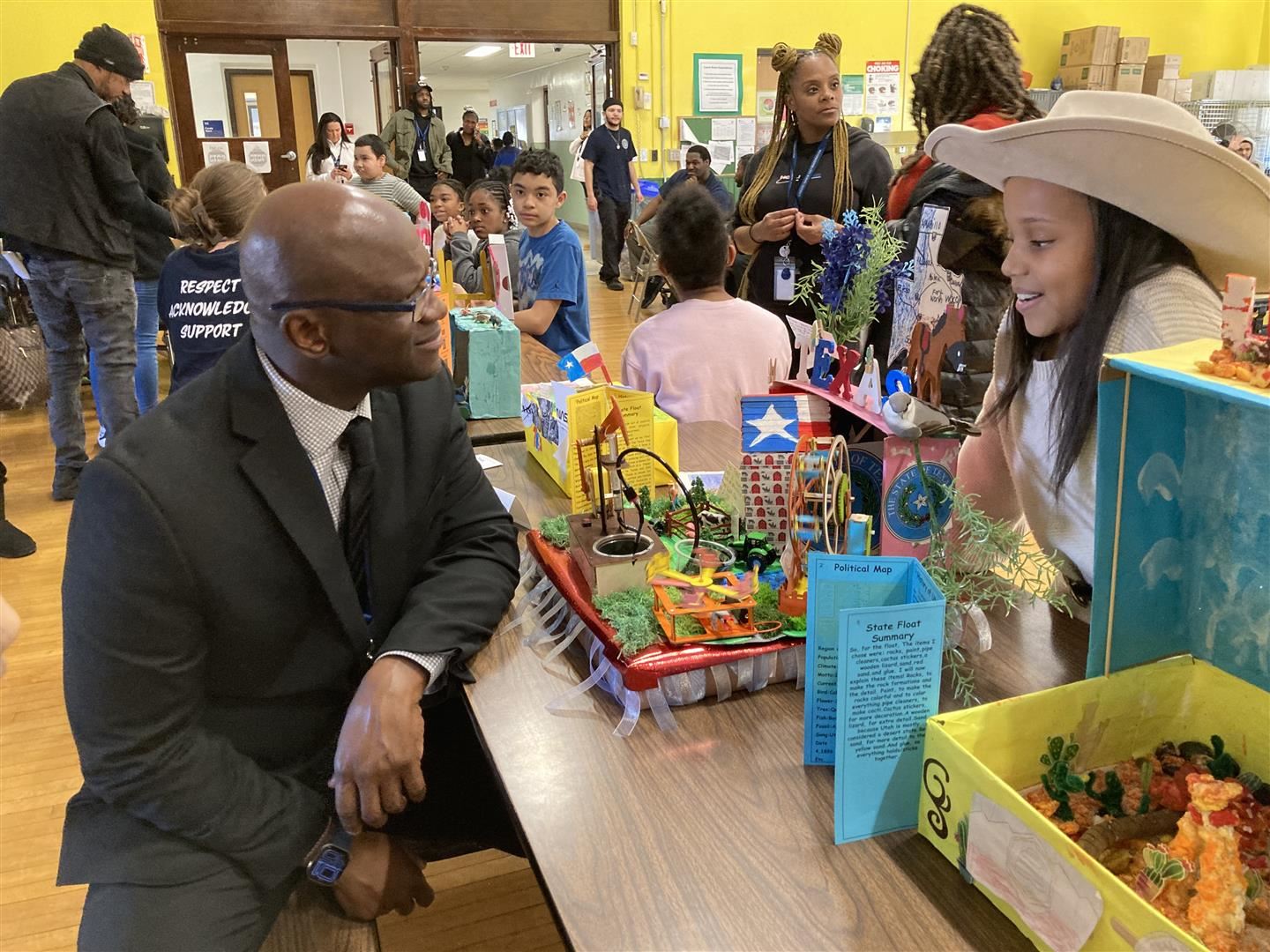  Assistant Superintendent for Elementary Education Gregory Mott speaks to a student about her float