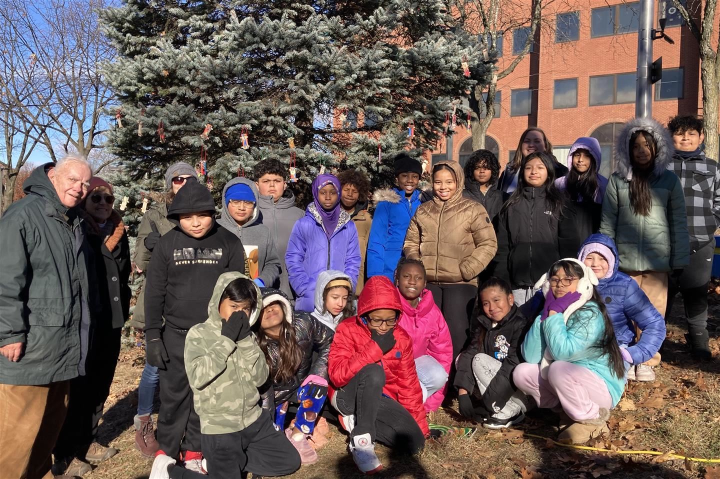  Morse students and teachers pose together at “Katie’s Tree” with Cliff Scholl, left.