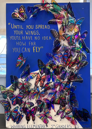 An art project with butterflies on a blue background