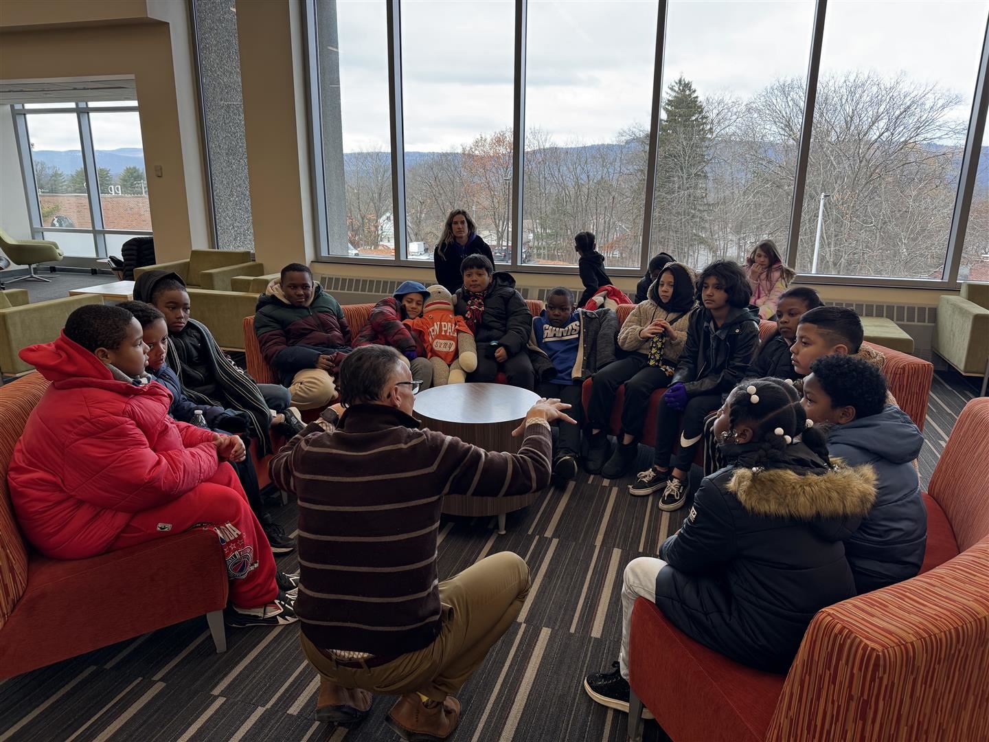 Warring students listen while sitting in the library on SUNY New Paltz&rsquo;s campus.