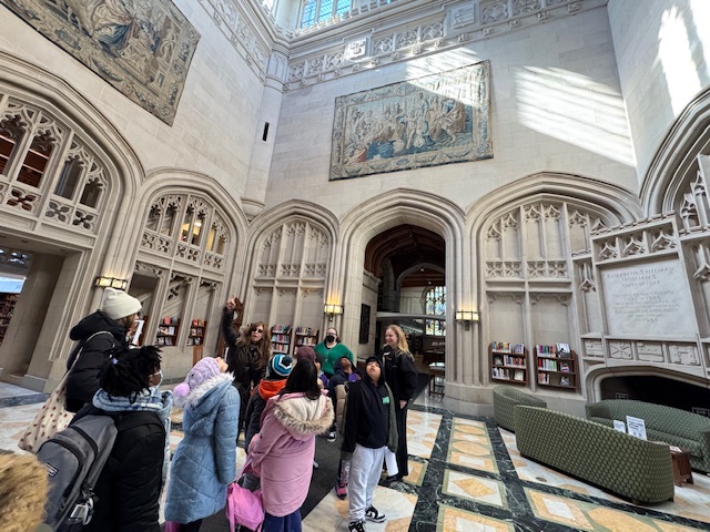  Students look around the lobby of a campus building