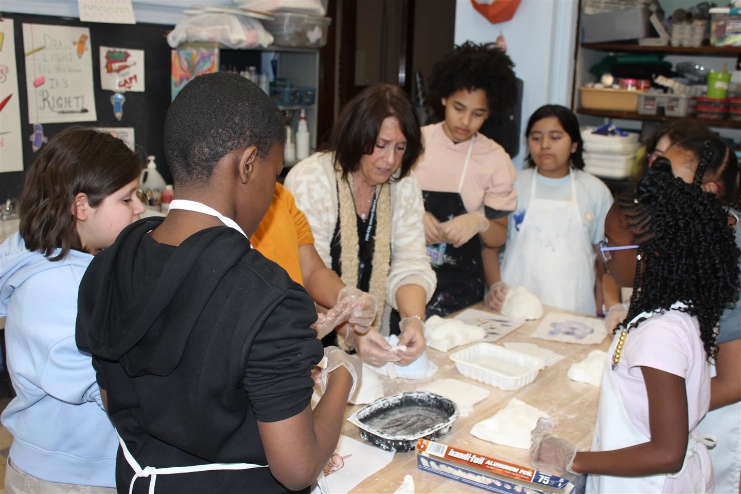  Warring Elementary art teacher Kathy Orza shows her fifth-grade students how to use plaster strips 