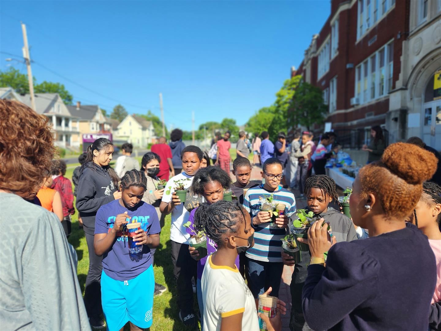 Warring Elementary students receive strawberry plants to take home after the Tree City USA event.