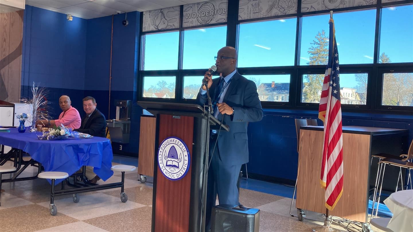 Gregory Mott speaks at a podium