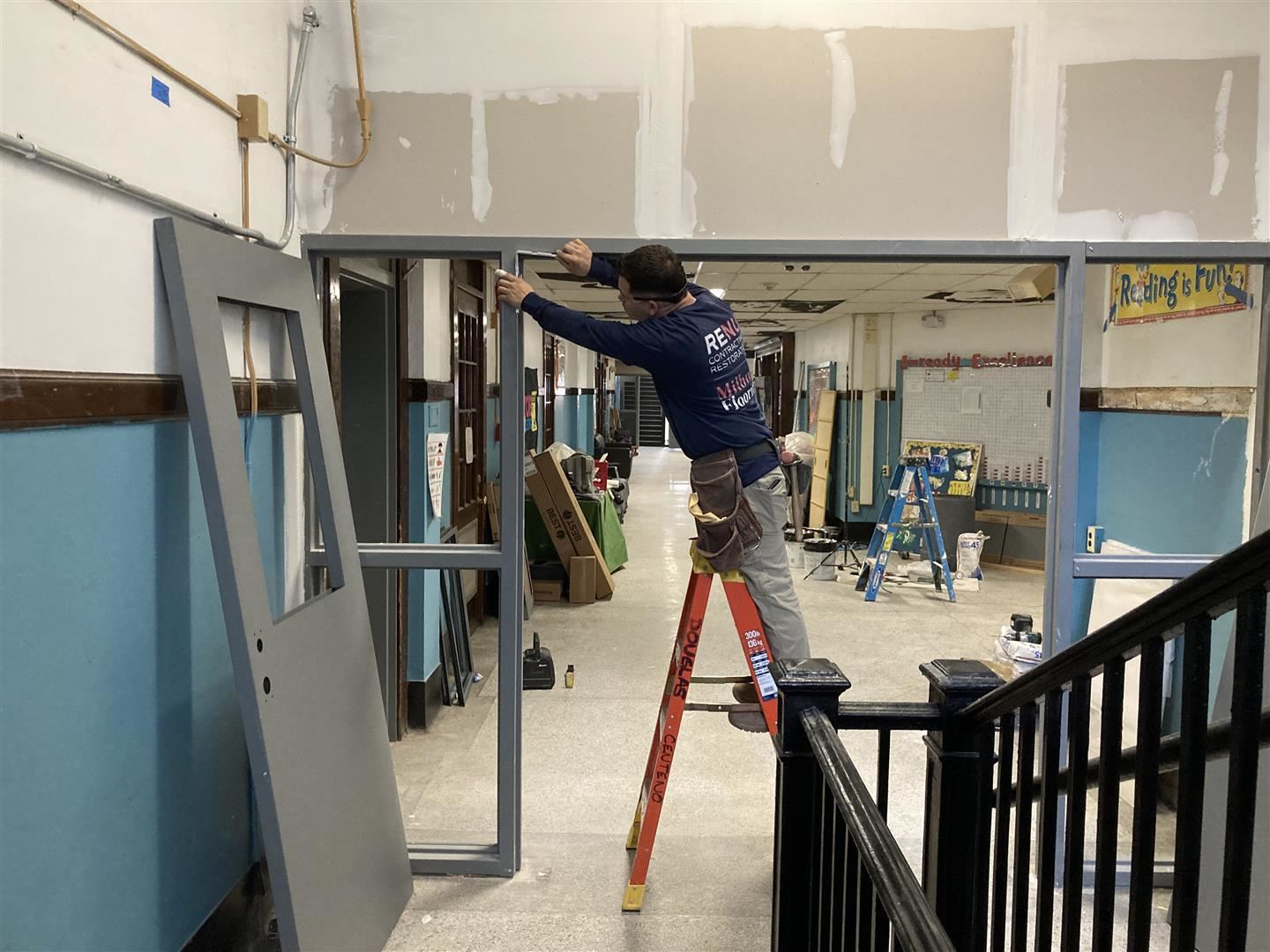  A worker installs a door.