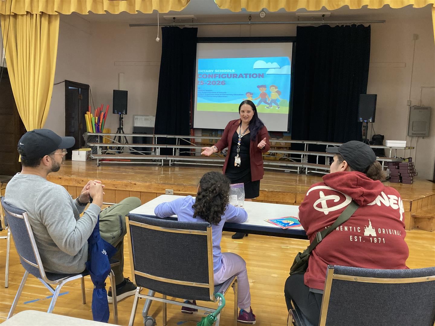  An administrator talks to three people at a presentation.