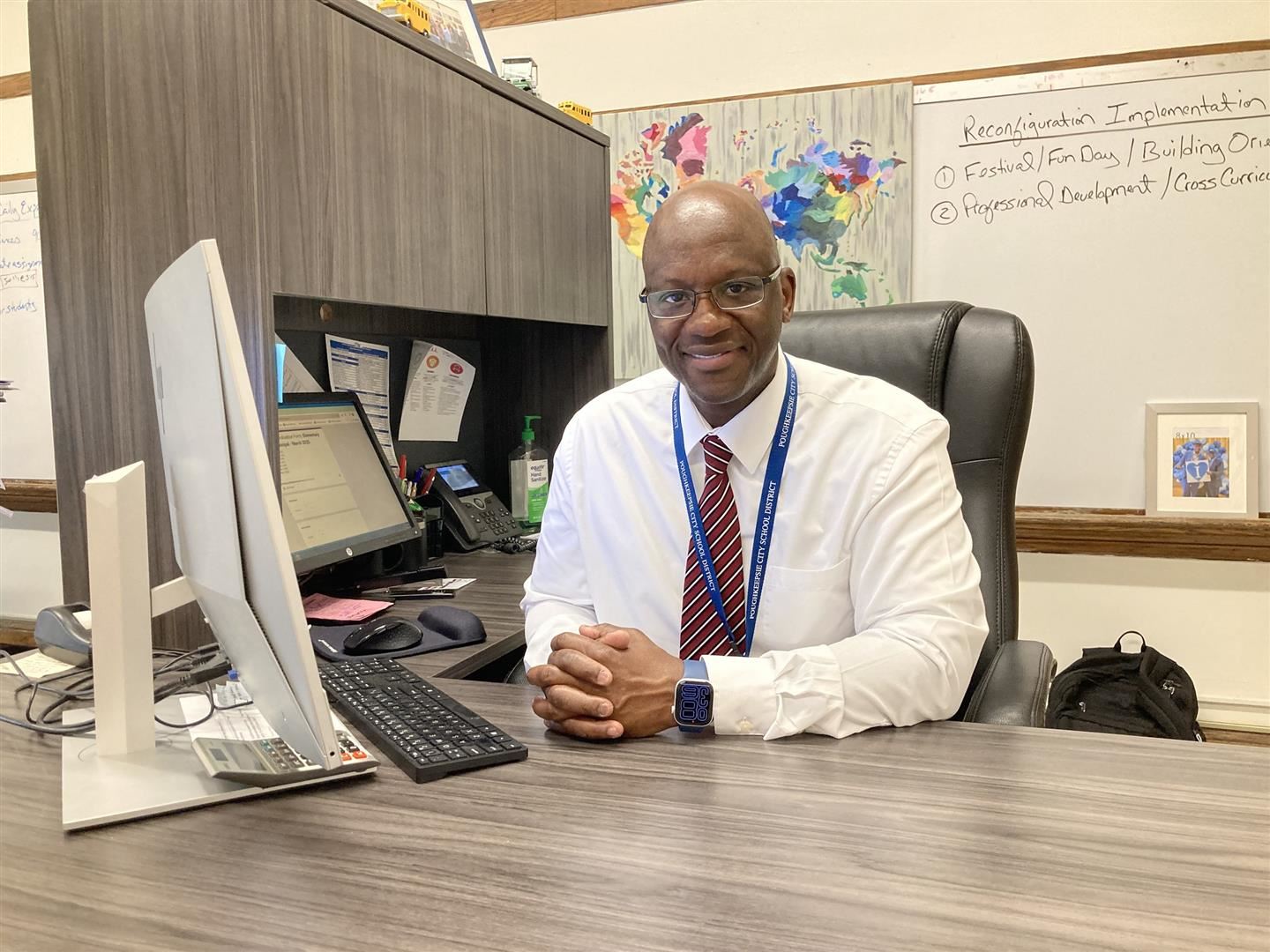  Gregory Mott sits at his desk