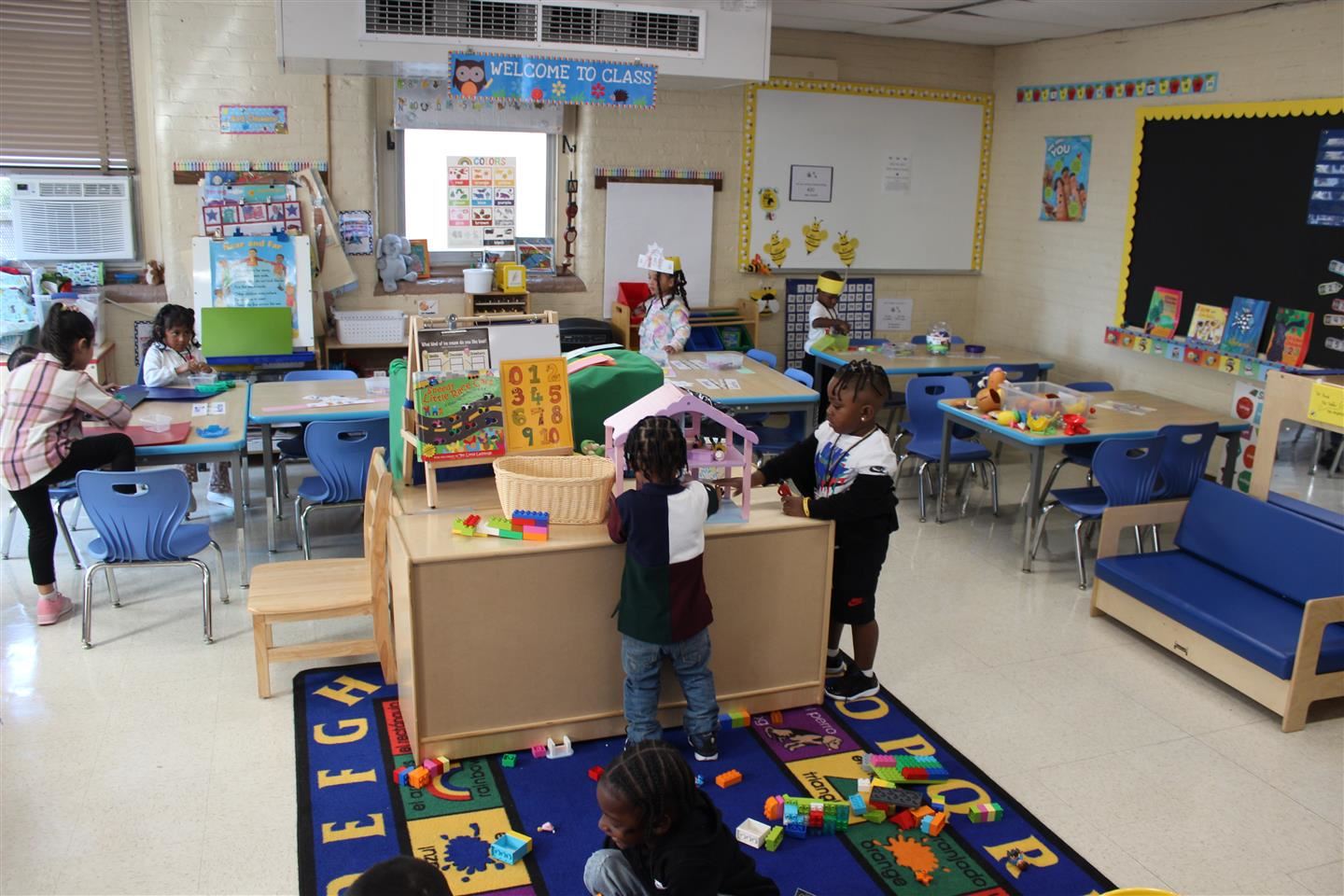  Five students play in a pre-K class.