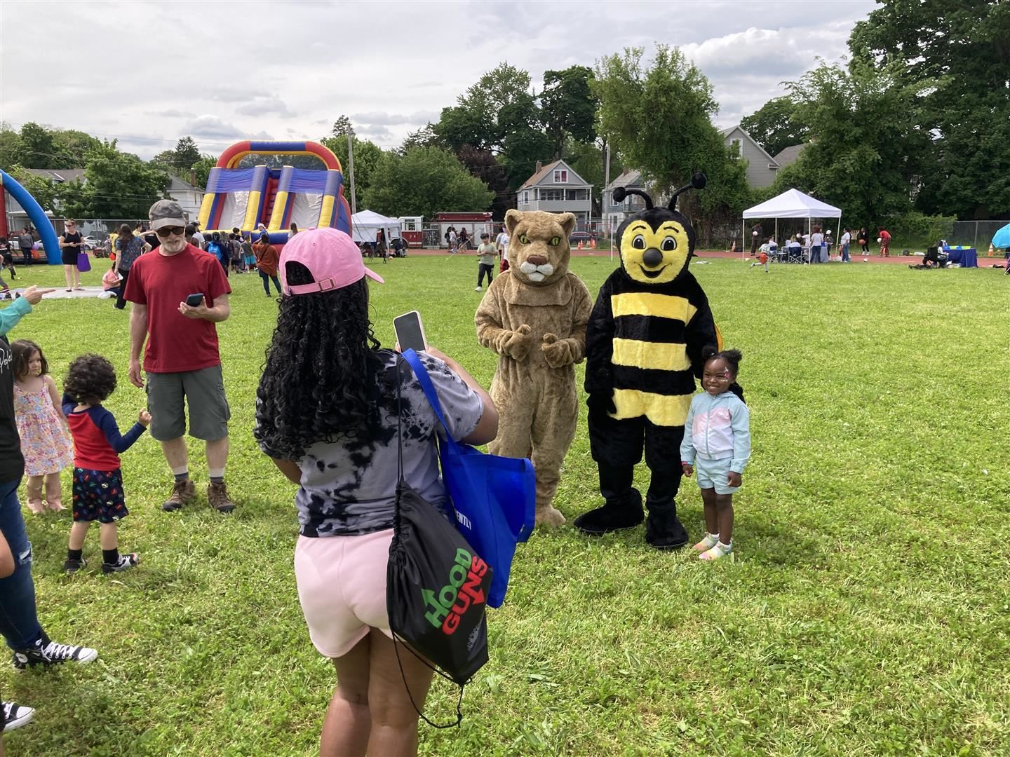 Student stands with mascots