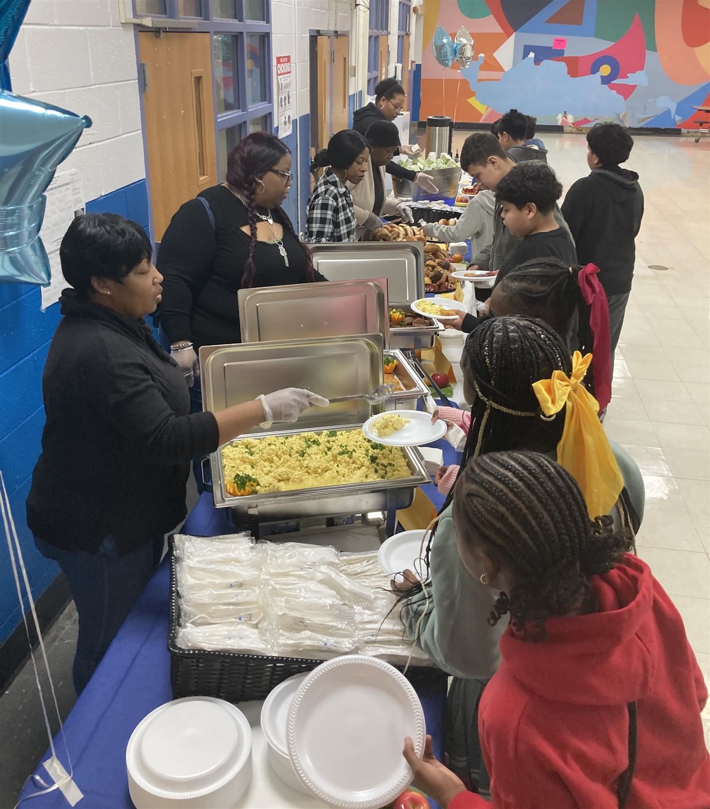  Students receive breakfast on a buffet line