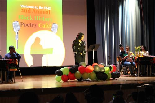 Brianna White recites a poem during the Black History Poetry Cafe at Poughkeepsie Middle School.