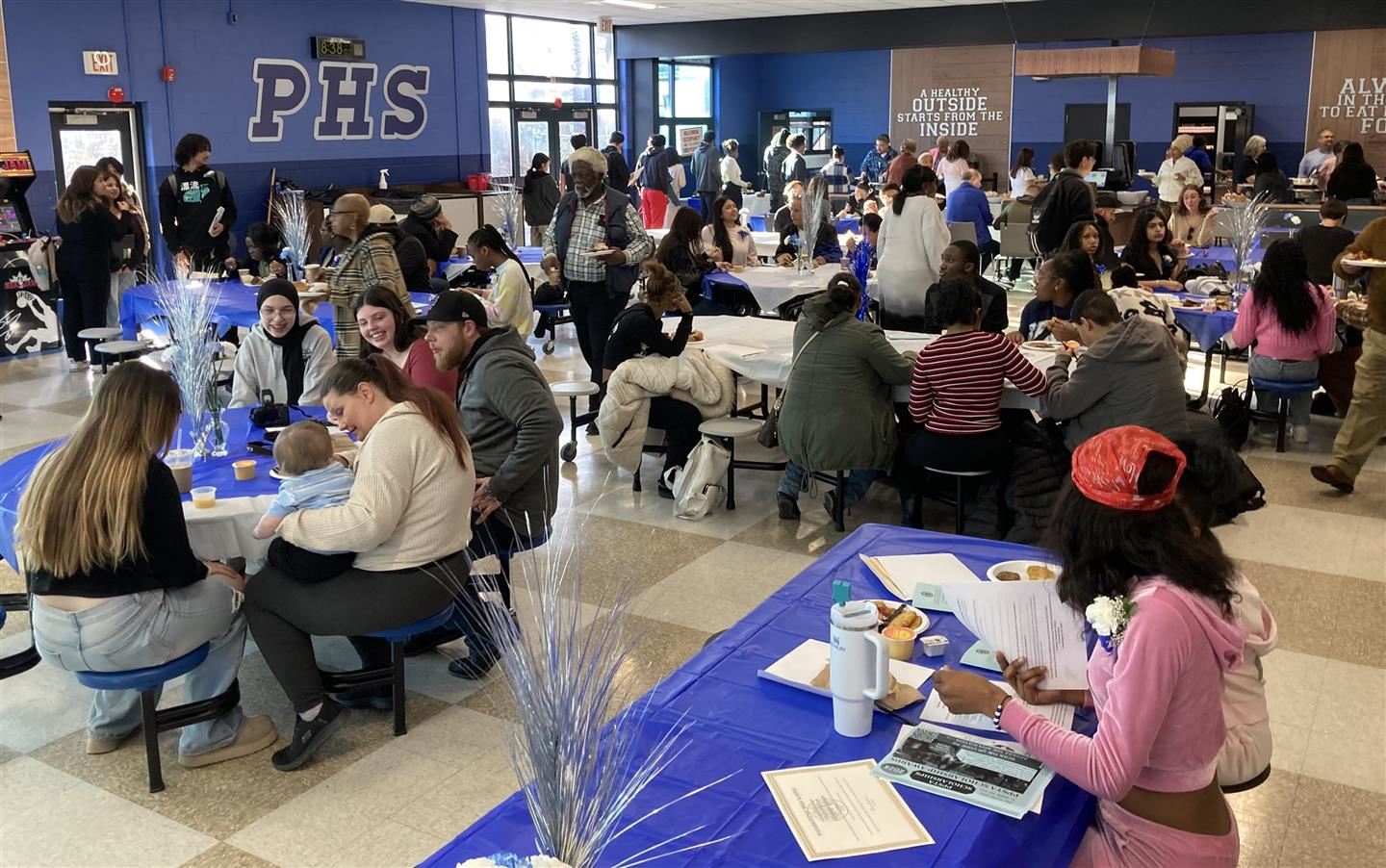 Students and families eat in the cafeteria