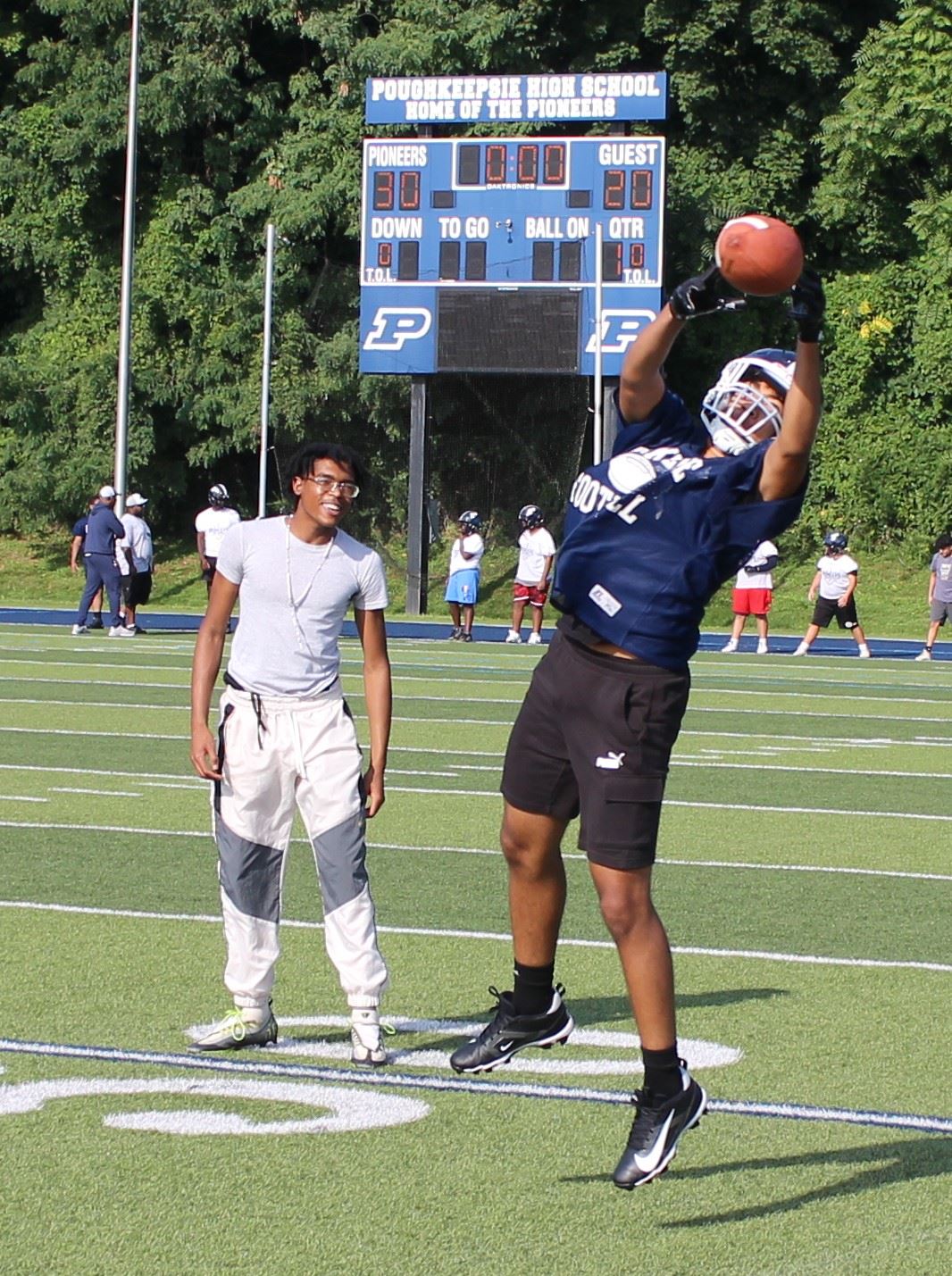  A Poughkeepsie football player catches a pass in practice