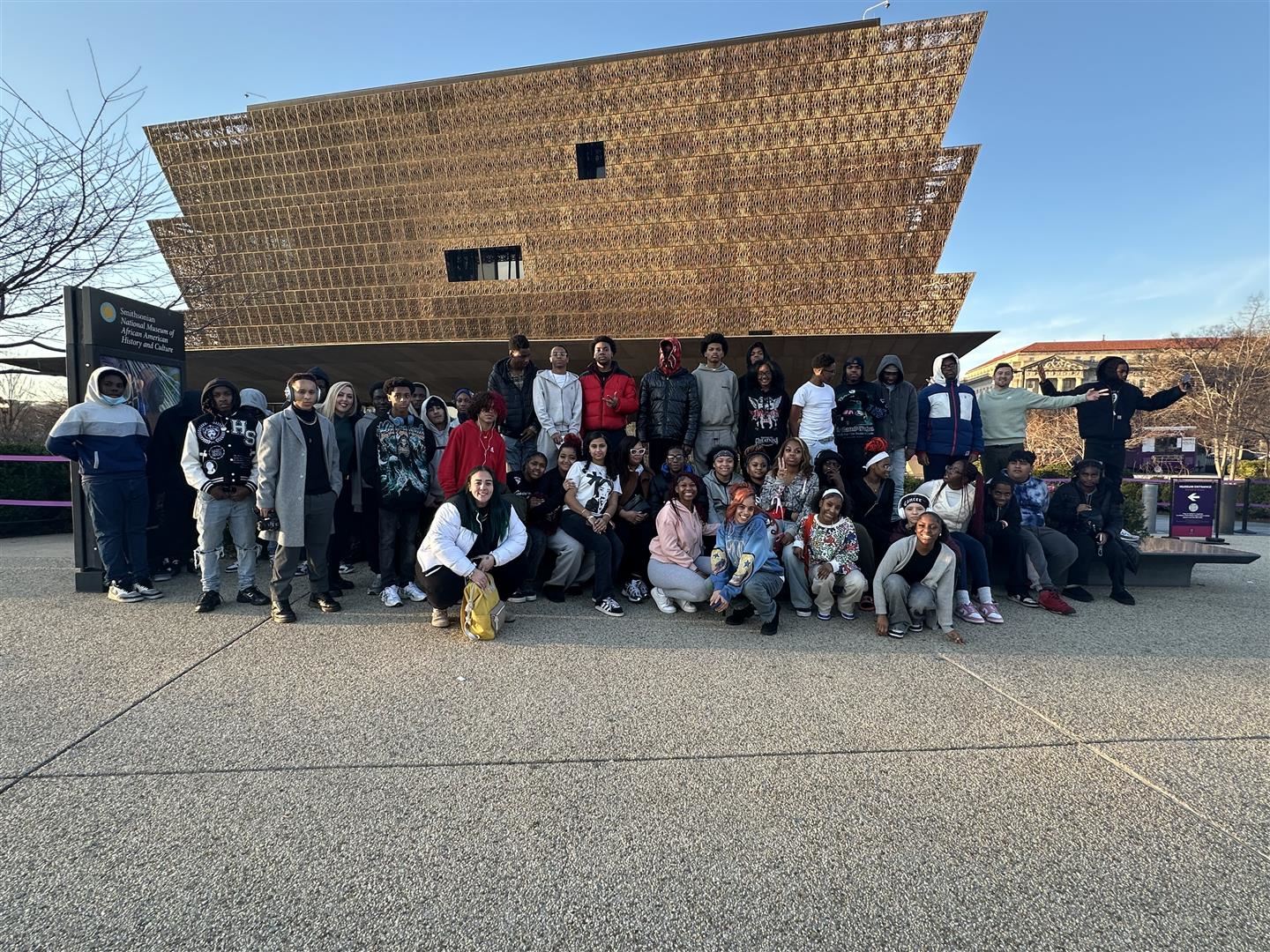  Several dozen students and chaperones pose outside a museum