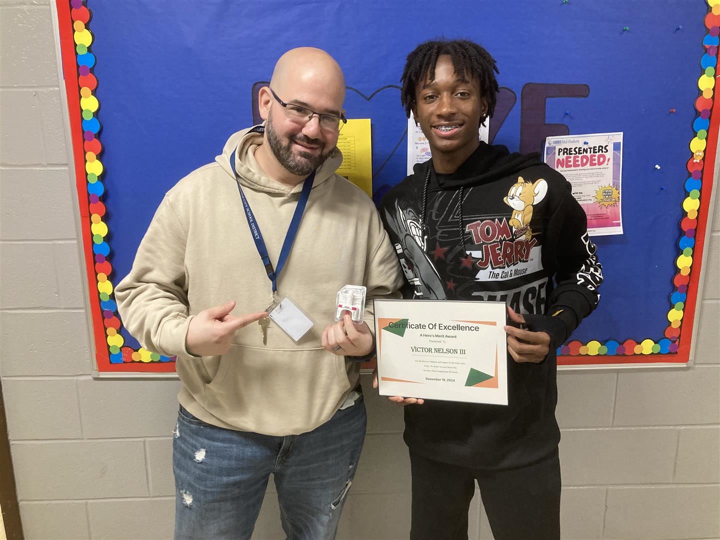  Victor Nelson, right, holds a certificate next to teacher Sean Lauder, who holds a dose of Narcan