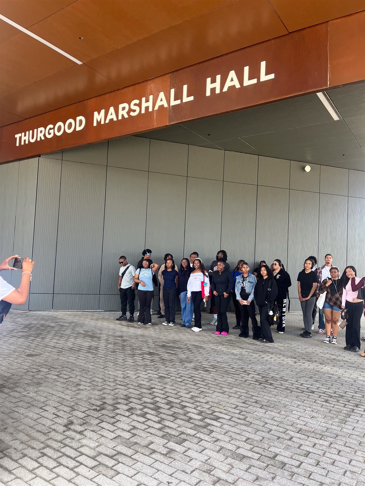  Students pose for a photo in a large group on Morgan State's campus