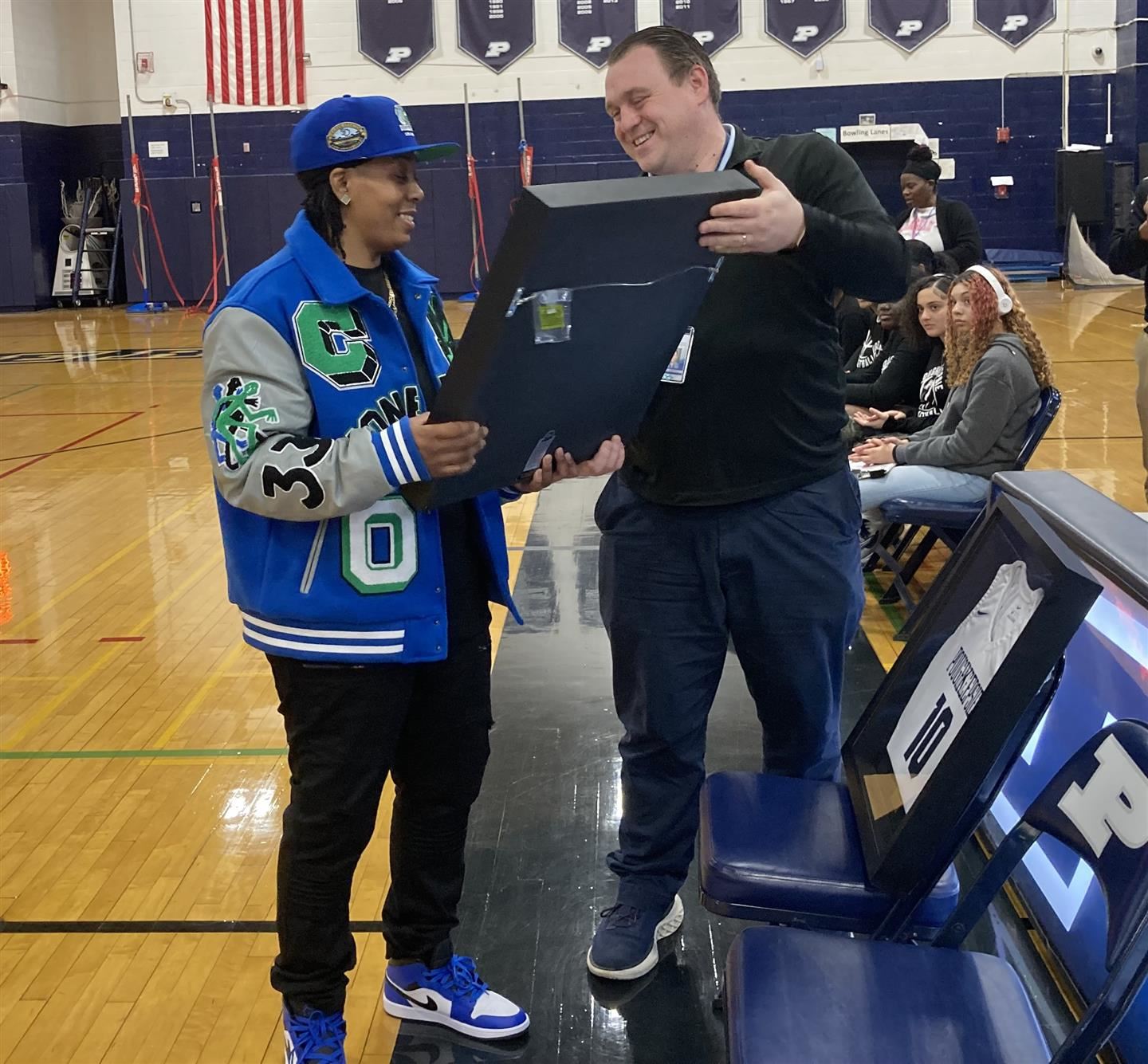  Terraya Richardson accepts a framed jersey on the gym floor from Peter Bianco.