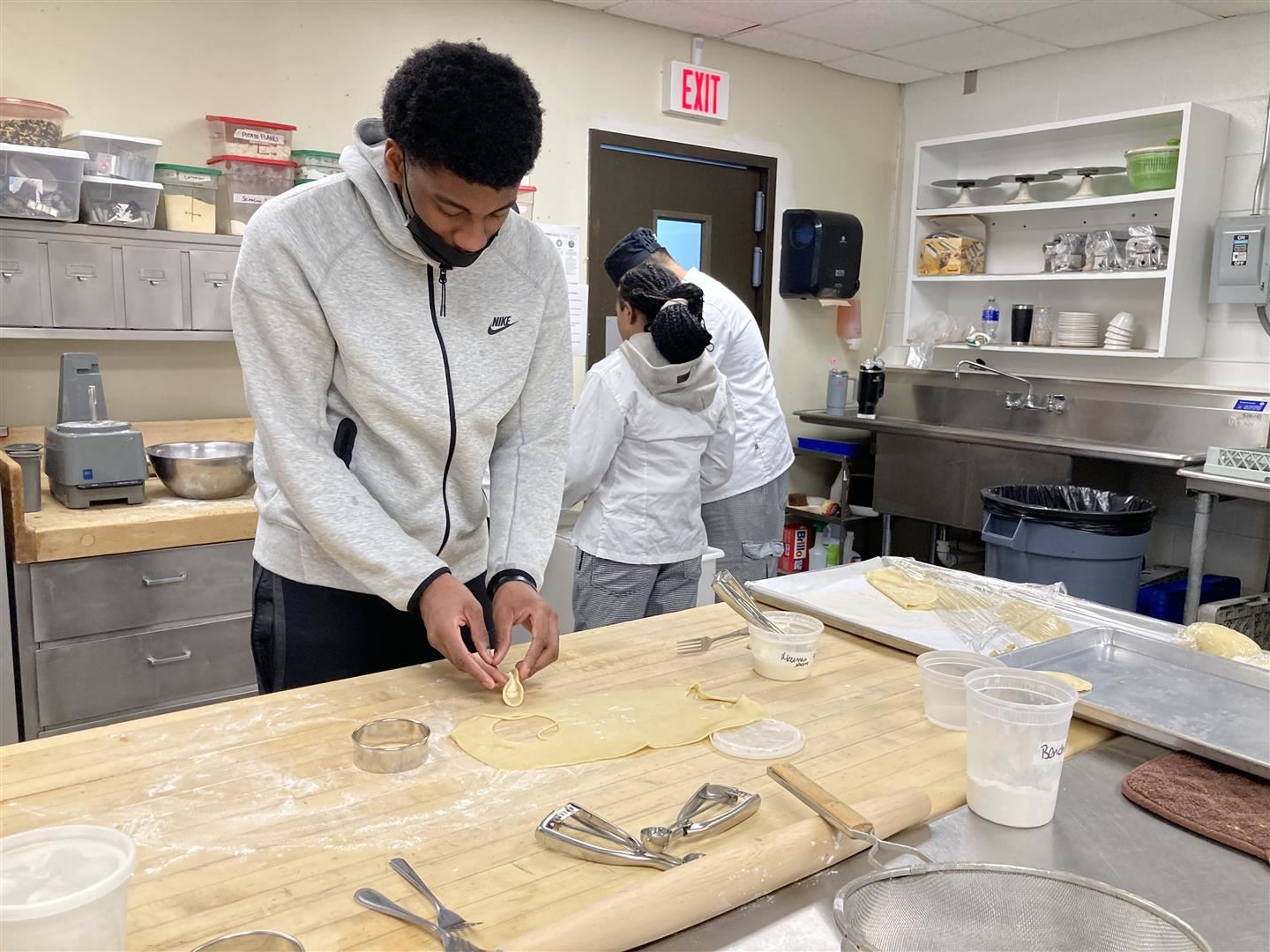 A student makes a pierogi in a kitchen
