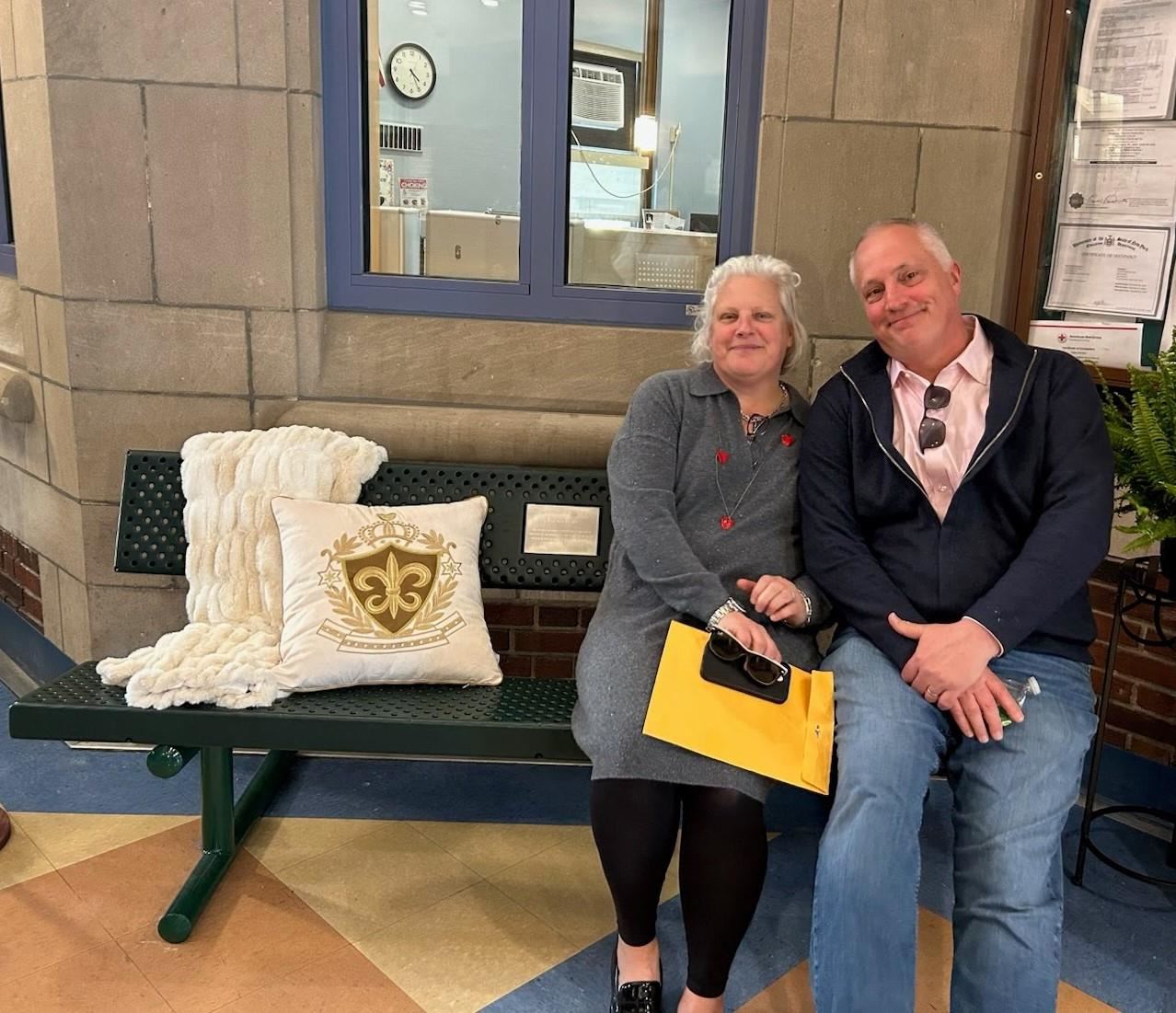  Mary Crown and her husband, William Ellis, sit on the bench dedicated to her sisters.
