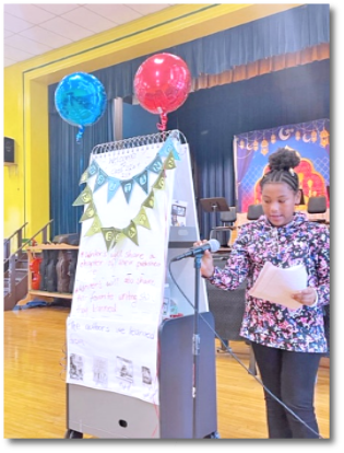 Realistic fiction reader - Description: A student reads a story she wrote at Krieger Elementary School's Realistic Fiction Party.