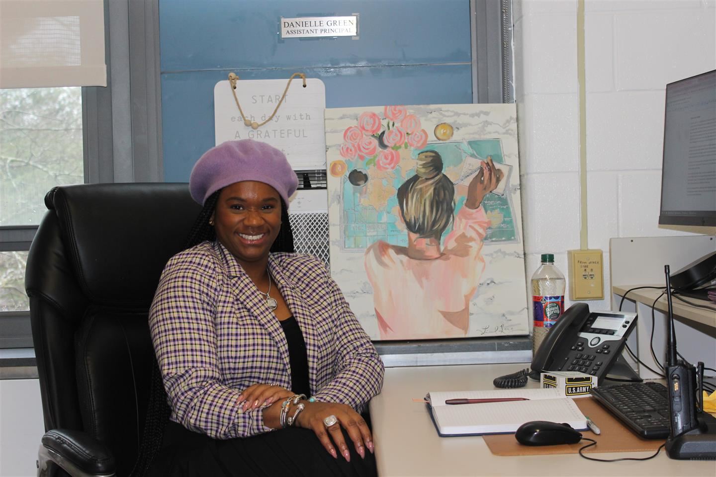 Danielle Green sits at her desk