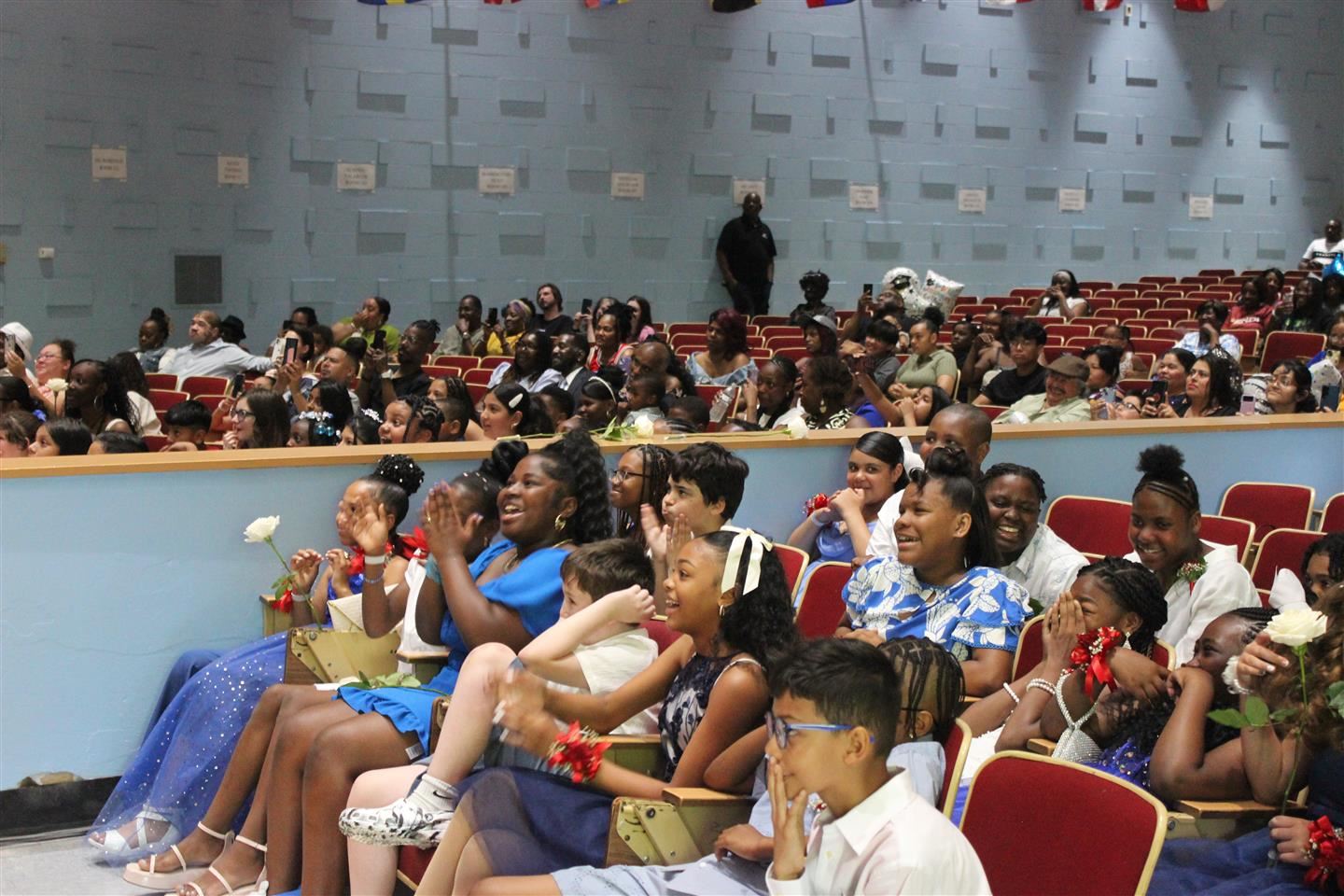 Students cheer and laugh while watching a retrospective video during the Clinton moving up ceremony at Poughkeepsie Middle Sc