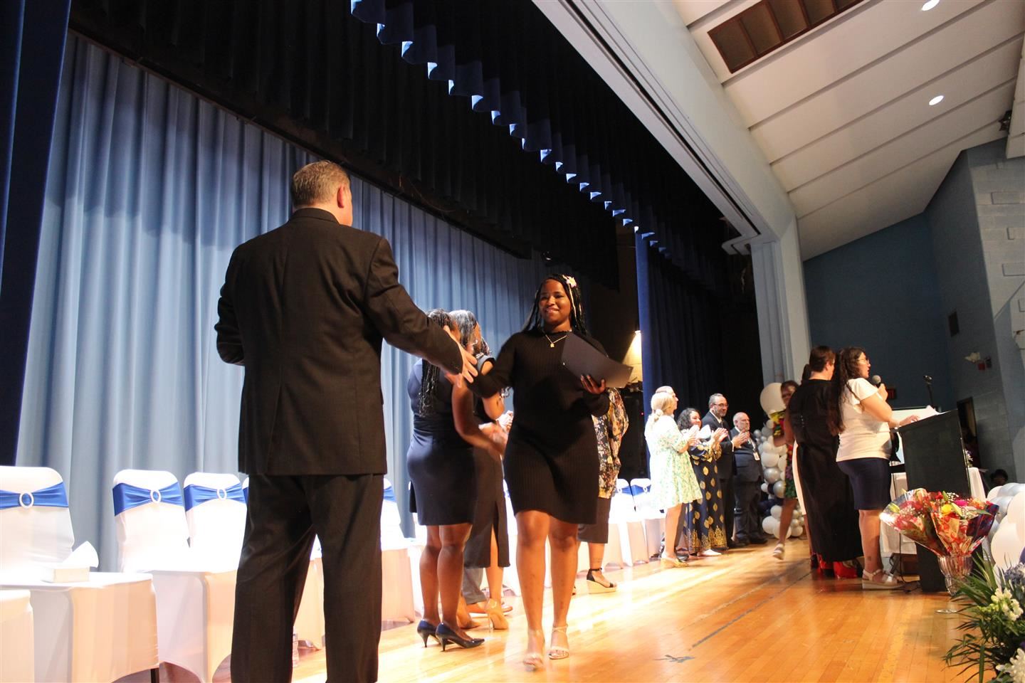  Asaliyah Lander shakes hands with Poughkeepsie Middle School Interim Principal Robert Parkes