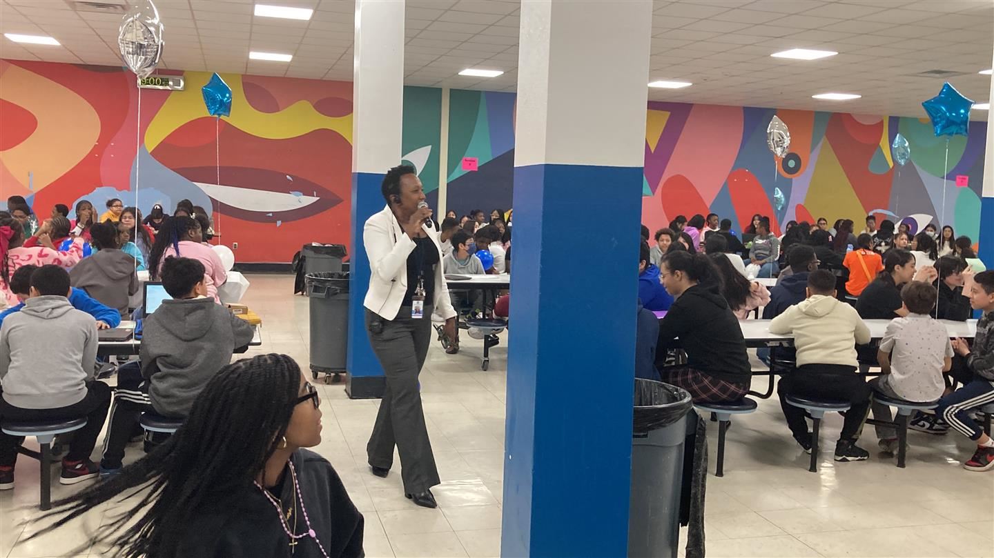 Interim Principal Felicia Schinella speaks to the students in the cafeteria.