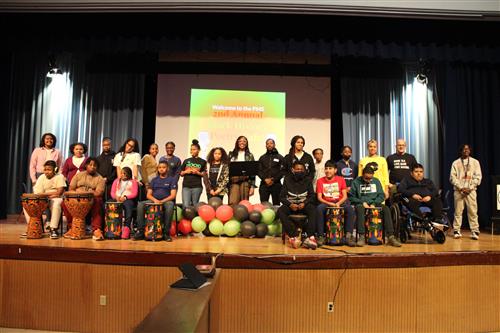 Performers in the Poughkeepsie Middle School Poetry Cafe pose together for a photo.