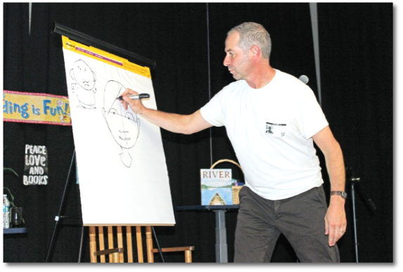 Author Elisha Cooper shows students how he draws character.