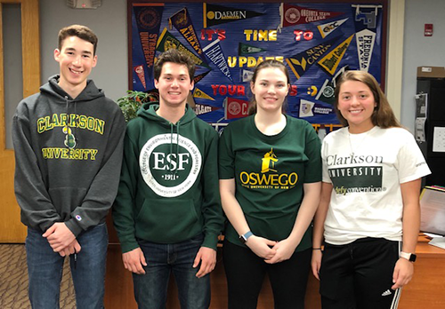 Four students smile.