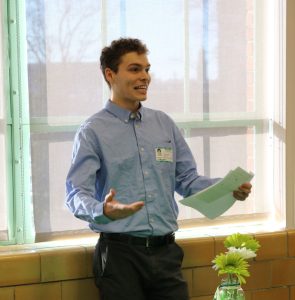 1 man presenting scholarship award