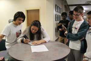 Students engraving their phone
