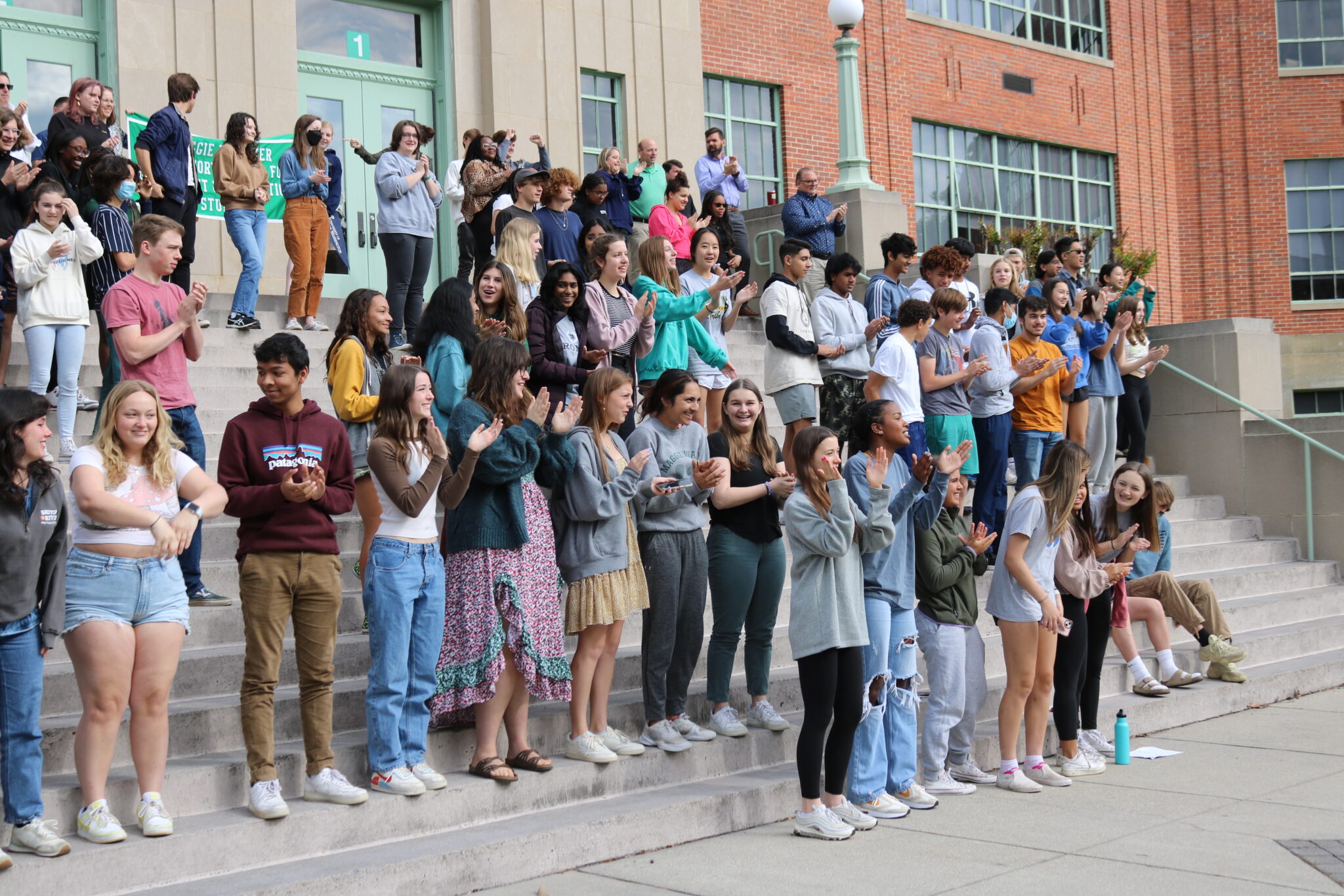Many students on the front steps of building