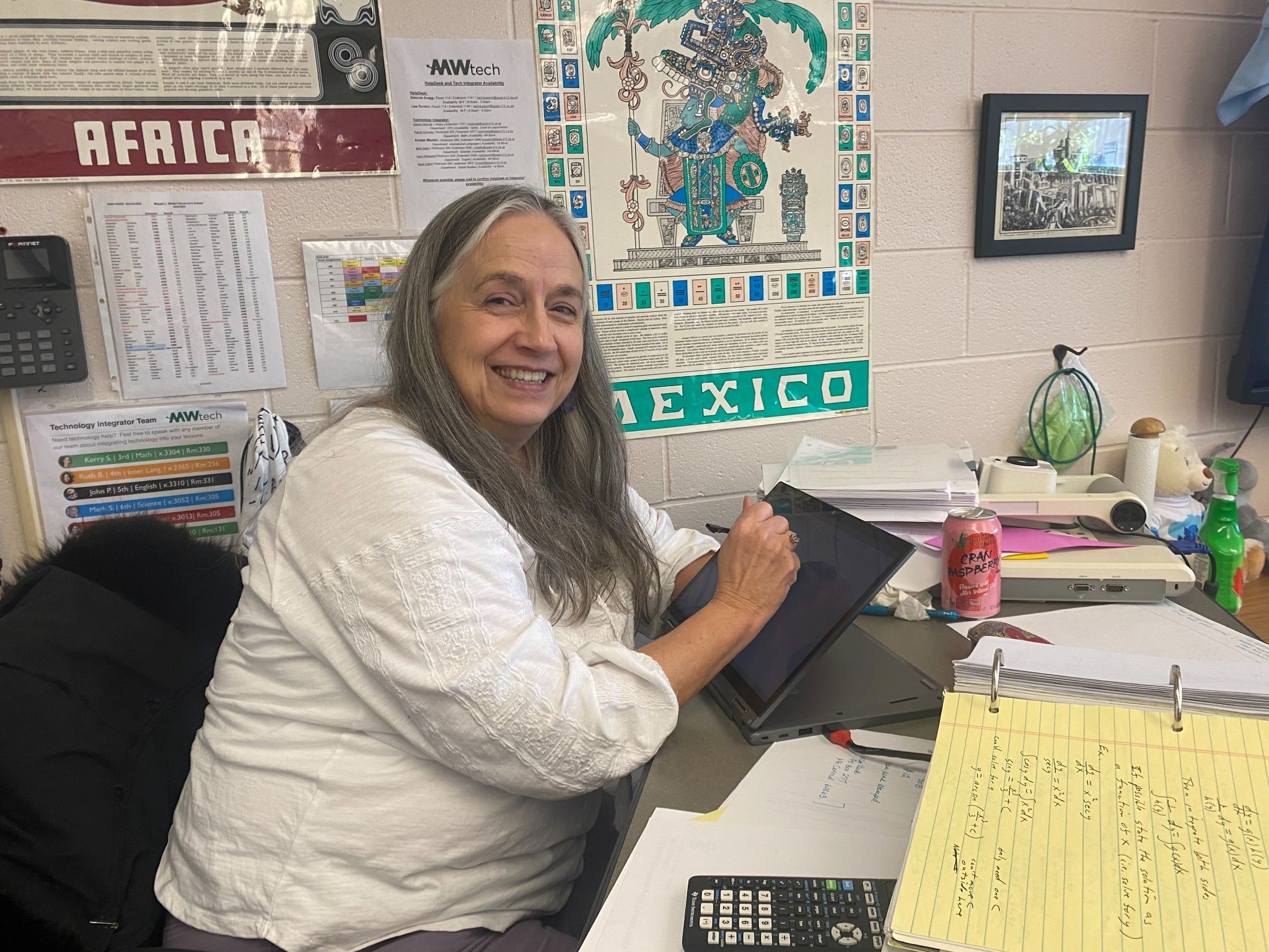 Teacher at desk in classroom