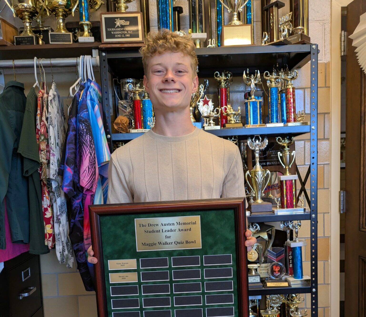 Student holding plaque