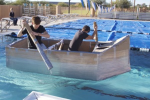two students in cardboard boat