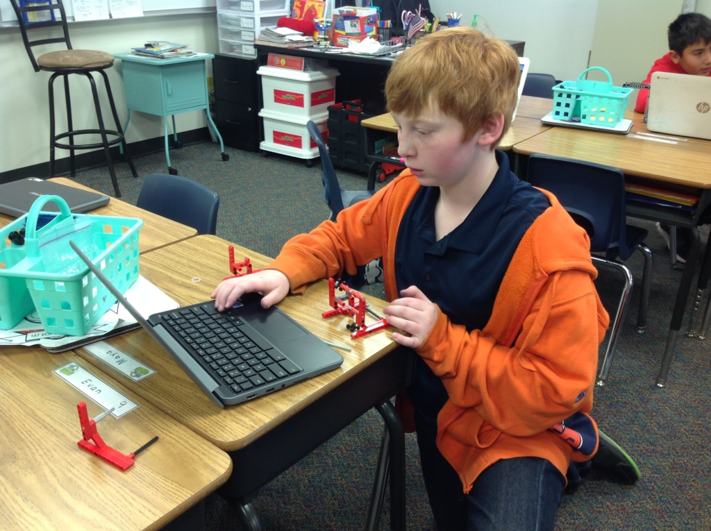 student kneeling at computer