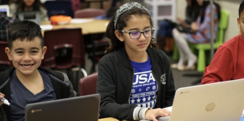 male and female students on computers