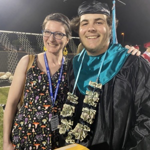 SDPA 2023 Graduation. Teacher taking picture with student.